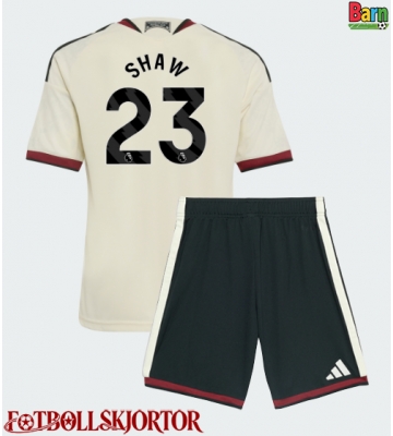 Manchester United Luke Shaw #23 Tredje Kläder Barn 2026-27 Kortärmad (+ Korta byxor)
